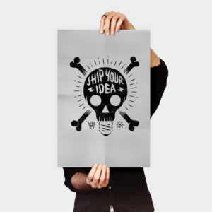 A person holding up a poster with skulls and crossbones.