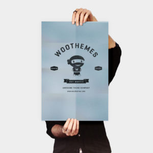 A person holding up a poster with the words woothemes on it.