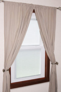 A window with curtains and blinds in it
