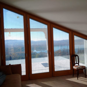 A room with large windows and a view of the mountains.
