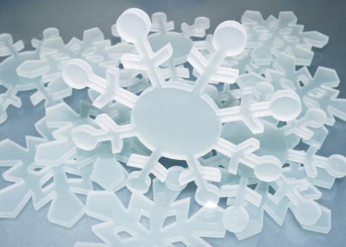A group of white plastic snowflakes sitting on top of each other.