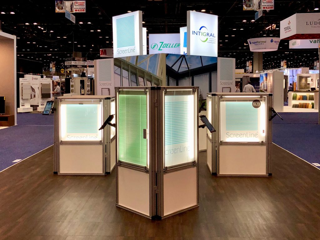 A group of three booths with lights on them.
