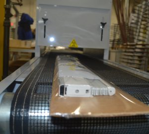 A conveyer belt with some boxes on it